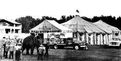 Lewis Bros. Circus midway and elephant ride